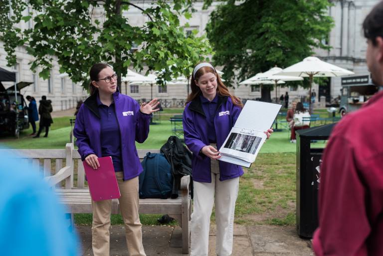 Two tour guides delivering material to the ϲʿWalking Tour attendees